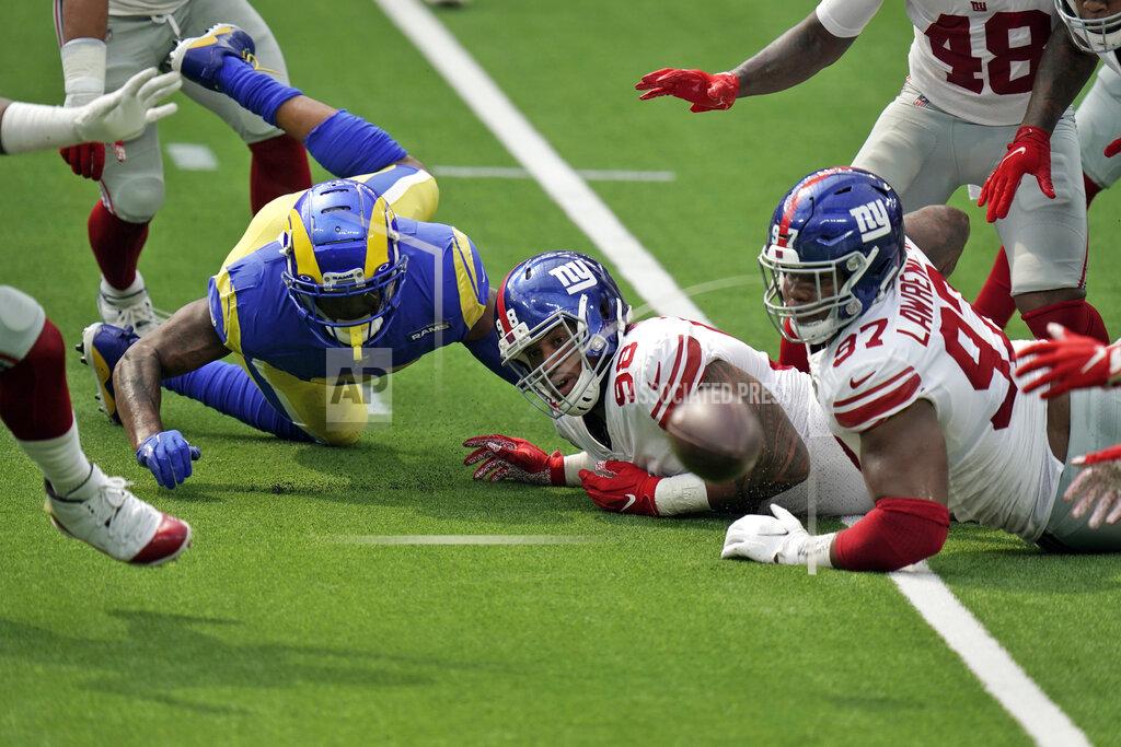 Jae C. Hong Los Angeles Rams tight end Gerald Everett, left, fumbles the ball which would then be recovered by the New York Giants during the first half of an NFL football game Sunday, Oct. 4, 2020, in Inglewood, Calif. (AP Photo/Jae C. Hong)