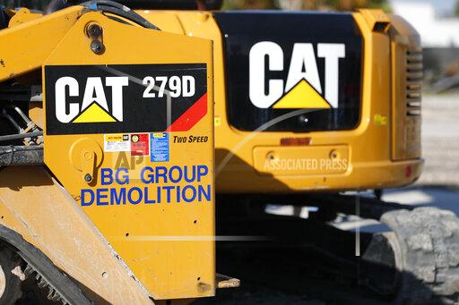 FILE - This May 8, 2019 photo shows a Caterpillar 279D Compact Track Loader at a demolition site in Fort Lauderdale, Fla. Caterpillar's revenue rose in the third quarter, bolstered by increased equipment demand and higher prices, Thursday, Oct. 28, 2021. (AP Photo/Wilfredo Lee, File)