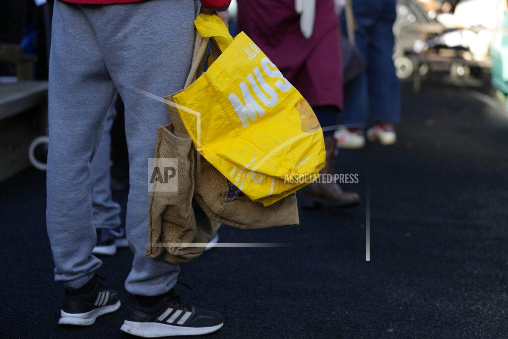 Frank Augstein FILE - Customers queue with empty bags as they wait for the opening of the community food pantry in Vauxhall, London, Nov. 16, 2022. In his first month as Britain's prime minister, Rishi Sunak has stabilized the economy, reassured allies from Washington to Kyiv and even soothed the European Union after years of sparring between Britain and the bloc. But Sunak’s challenges are just beginning. He is facing a stagnating economy, a cost-of-living crisis – and a Conservative Party that is fractious and increasingly unpopular after 12 years in power. (AP Photo/Frank Augstein, File)