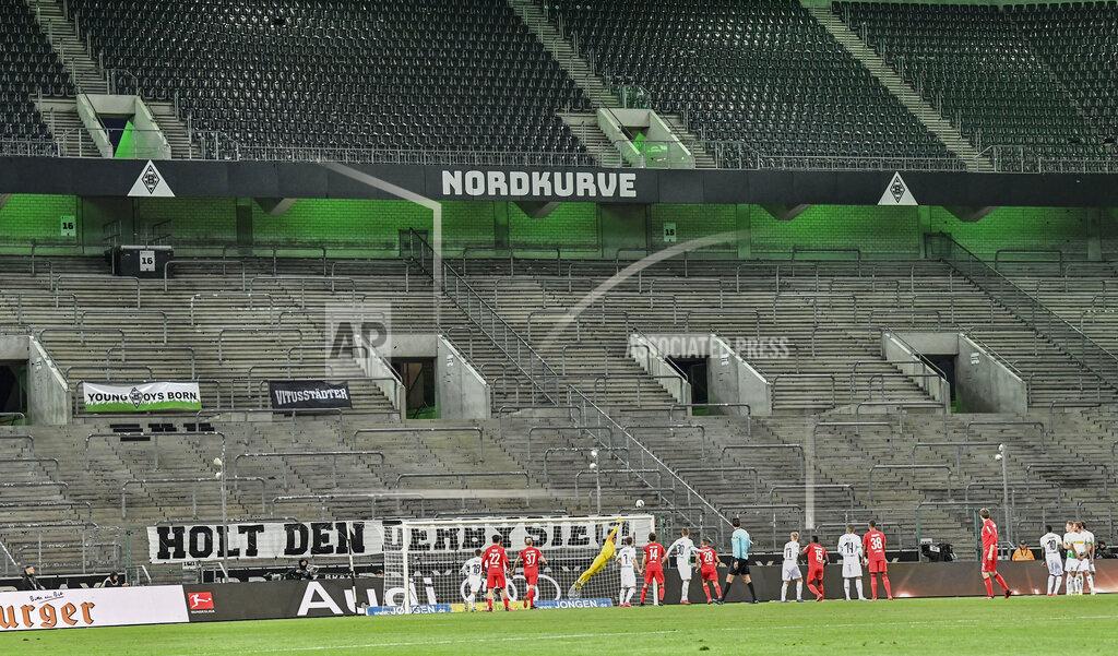 Martin Meissner FILE - In this March 11, 2020 file photo, players challenge for the ball in an empty stadium during the German Bundesliga soccer match between Borussia Moenchengladbach and 1.FC Cologne in Moenchengladbach, Germany. (AP Photo/Martin Meissner, file)