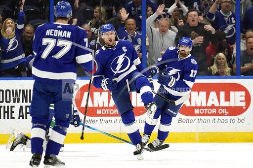 Tampa Bay Lightning center Steven Stamkos (91) celebrates his goal against the Vancouver Canucks with defenseman Victor Hedman (77) and left wing Alex Killorn (17) during the first period of an NHL hockey game Thursday, Jan. 13, 2022, in Tampa, Fla. (AP Photo/Chris O'Meara)