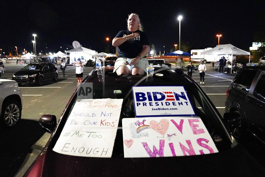 Tracy Holden of Wilmington, Del., during the Pledge of Allegiance, outside the venue where Democratic presidential candidate former Vice President Joe Biden will speak later tonight, during the final day of the Democratic National Convention, Thursday, Aug. 20, 2020, at the Chase Center in Wilmington, Del. (AP Photo/Carolyn Kaster)