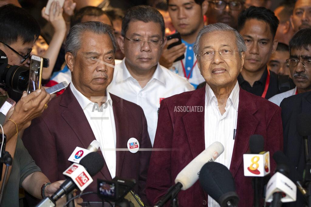 Vincent Thian In this May 9, 2018, photo, Mahathir Mohamad, right, speaks to media during a press conference to announce victory on election as Muhyiddin Yassin, president of Malaysian United Indigenous Party stands next to him at a hotel in Kuala Lumpur, Malaysia. Malaysian ex-Prime Minister Mahathir has been ousted from his Malay party in the latest twist to a power struggle with his successor Muhyiddin Yassin, but he has vowed to challenge it. (AP Photo/Vincent Thian)