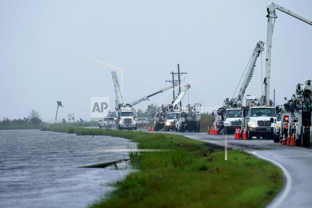 Gerald Herbert Utility crews replace power poles destroyed by Hurricane Ida as Tropical Storm Nicholas approaches in Pointe-aux-Chenes, La., Tuesday, Sept. 14, 2021. (AP Photo/Gerald Herbert)