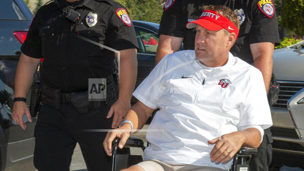 Matt Bell Liberty head football coach Hugh Freeze arrives to coach from a wheelchair in the coaches' box against Syracuse in an NCAA college football game in Lynchburg, Va., Saturday, Aug. 31, 2019. (AP Photo/Matt Bell)