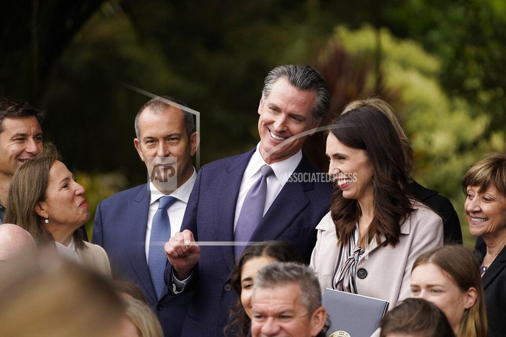 Eric Risberg California Gov. Gavin Newsom and New Zealand Prime Minister Jacinda Ardern laugh while posing in a group photo after an event at the San Francisco Botanical Garden in San Francisco, Friday, May 27, 2022. Newsom met with Ardern in Golden Gate Park "to establish a new international partnership tackling climate change." At lower left is California Lt. Gov. Eleni Kounalakis. (AP Photo/Eric Risberg)