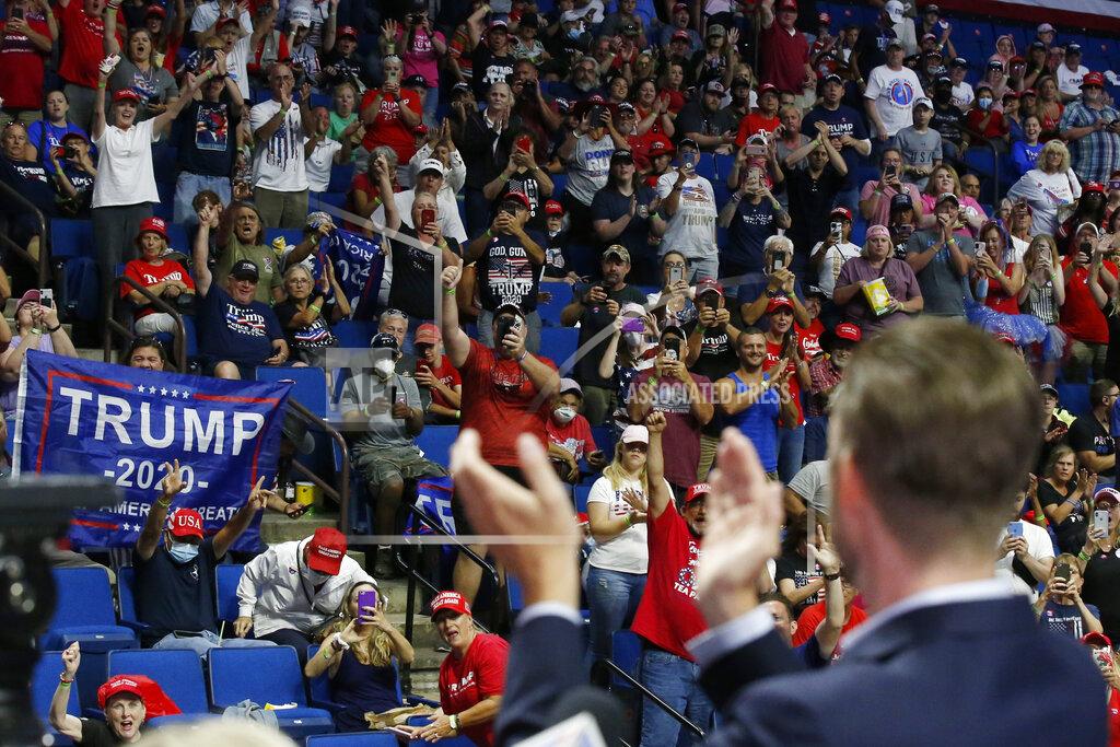 Sue Ogrocki President Donald Trump supporters cheer Eric Trump, the son of President Donald Trump, before a Trump campaign rally in Tulsa, Okla., Saturday, June 20, 2020. (AP Photo/Sue Ogrocki)