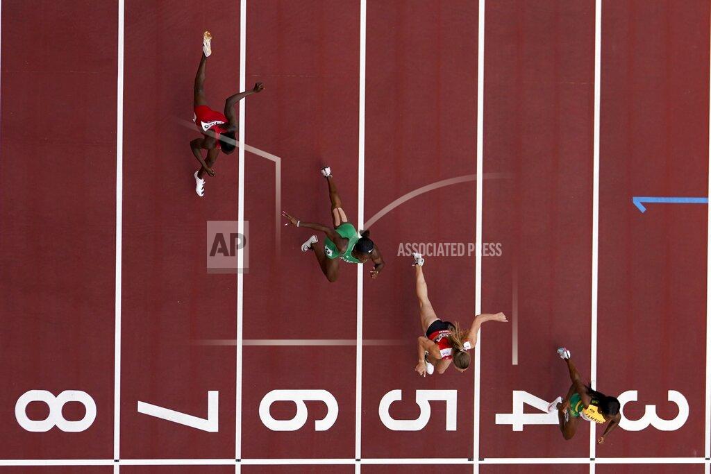 Morry Gash Shelly-Ann Fraser-Pryce, of Jamaica, Ajla Del Ponte, of Switzerland, Nzubechi Nwokocha, of Nigeria, and Gina Bass, of Gambia, compete during the first round of the women's 100-meter the 2020 Summer Olympics, Friday, July 30, 2021, in Tokyo. (AP Photo/Morry Gash)