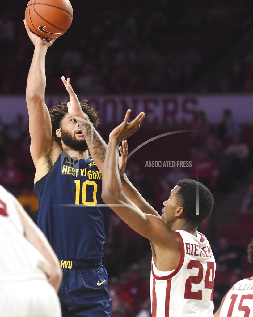 Kyle Phillips West Virginia guard Jermaine Haley (10) shoots the ball over Oklahoma guard Jamal Bieniemy (24) during the first half of an NCAA college basketball game in Norman, Okla., Saturday, Feb. 8, 2020. (AP Photo/Kyle Phillips)