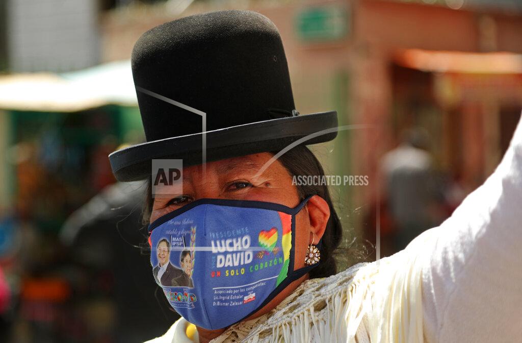 Martin Mejia A supporter of presidential candidate Luis Arce stands outside Arce's headquarters one day after elections in La Paz, Bolivia, Monday, Oct. 19, 2020, amid the COVID-19 pandemic. Evo Morales' party, with Arce as its candidate, claimed victory in a presidential election that appeared to reject the right-wing policies of the interim government that took power in Bolivia after the leftist leader resigned and fled the country a year ago. (AP Photo/Martin Mejia)