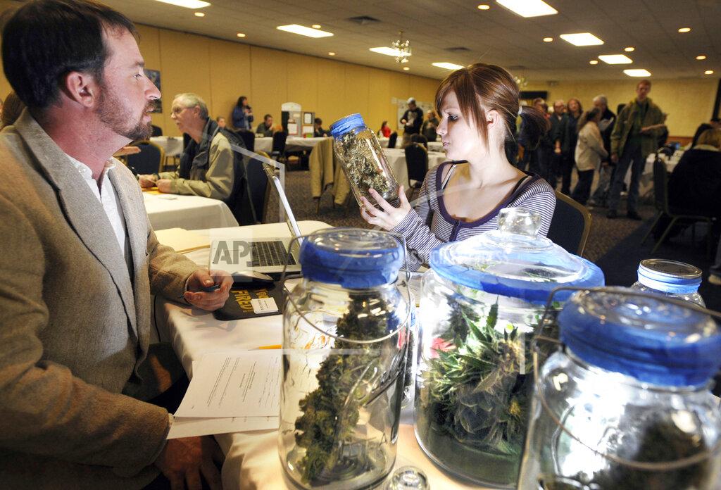 James Woodcock FILE - In this Jan. 24, 2010 file photo, Todd Wagner, left, a medical marijuana caregiver sits with other vendors during the Medical Marijuana Clinic in Billings, Mont. Voters in four states could embrace broad legal marijuana sales on Election Day, setting the stage for a watershed year for the industry that could snowball into neighboring states as well as reshape policy on Capitol Hill. The Nov. 3, 2020, contests will take place in markedly different regions of the country, New Jersey, Arizona, South Dakota and Montana and approval of the proposals would highlight how public acceptance of cannabis is cutting across geography, demographics and the nation's deep political divide. (James Woodcock/The Billings Gazette via AP, File)