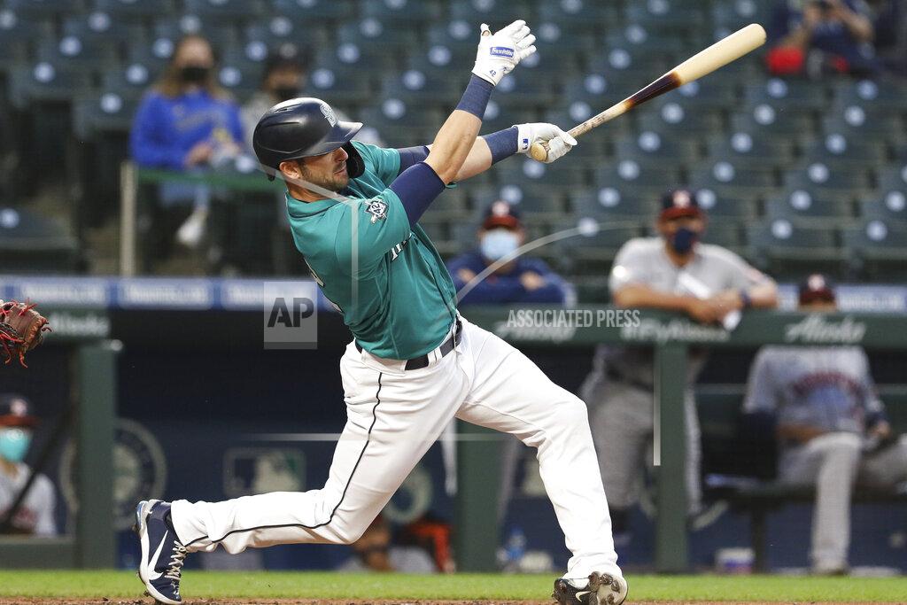 Jason Redmond Seattle Mariners' Mitch Haniger singles on a line drive during the third inning of the team's baseball game against the Houston Astros on Friday, April 16, 2021, in Seattle. (AP Photo/Jason Redmond)