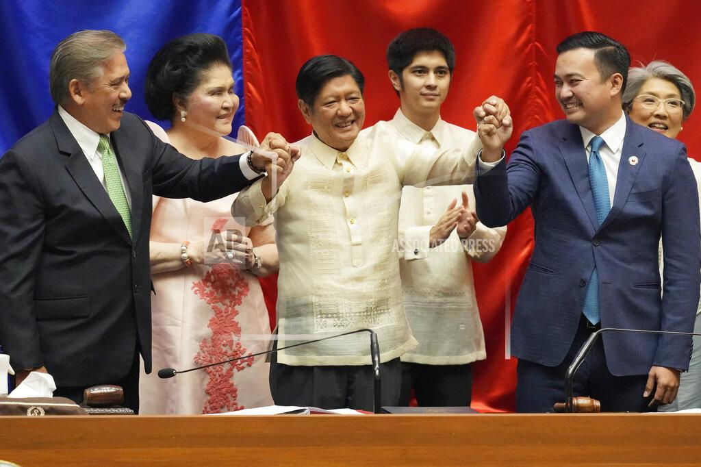 Aaron Favila President-elect Ferdinand 'Bongbong" Marcos Jr., center, raises hands with Senate President Vicente Sotto III, left, and House Speaker Lord Allan Velasco during his proclamation at the House of Representatives, Quezon City, Philippines on Wednesday, May 25, 2022. Marcos Jr. was proclaimed the next president of the Philippines by a joint session of Congress Wednesday in an astonishingly huge electoral triumph 36 years after his father was ousted as a brutal dictator by a pro-democracy uprising. At back is Imelda Marcos. (AP Photo/Aaron Favila)