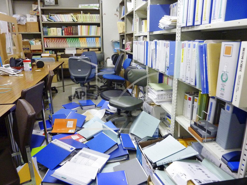 Uncredited Files are scattered following an earthquake at a meeting room of Kyodo News Sendai branch office in Sendai, Miyagi prefecture, northeastern Japan Saturday, Feb. 13, 2021. The Japan Meteorological Agency says a strong earthquake has hit off the coast of northeastern Japan, shaking Fukushima, Miyagi and other areas. (Kyodo News via AP)