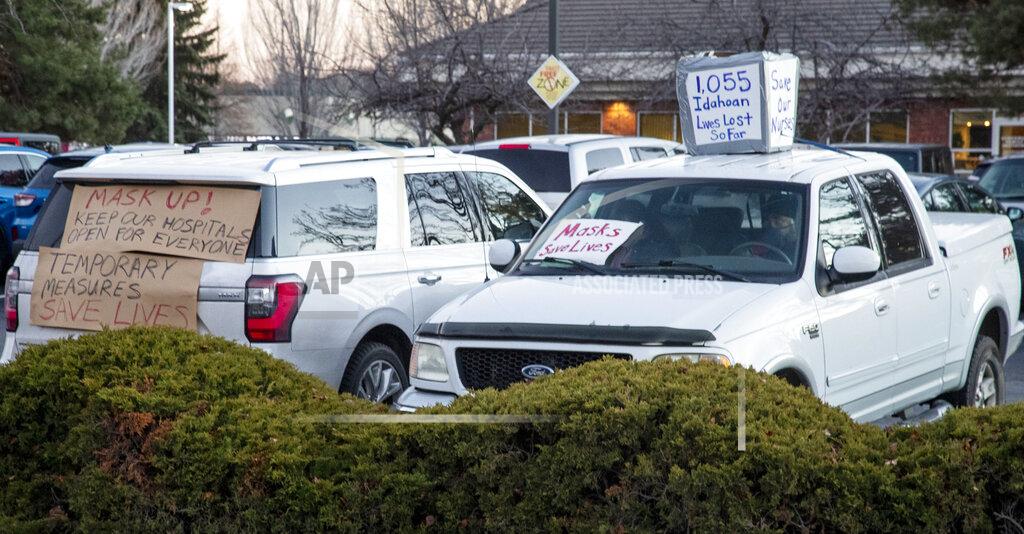 Darin Oswald Supporters of health workers and mask mandates held a silent counter protest by decorating their vehicles at an anti-mask protest at the Central District Health offices, Tuesday, Dec. 8, 2020 in Boise, Idaho. (Darin Oswald/Idaho Statesman via AP)