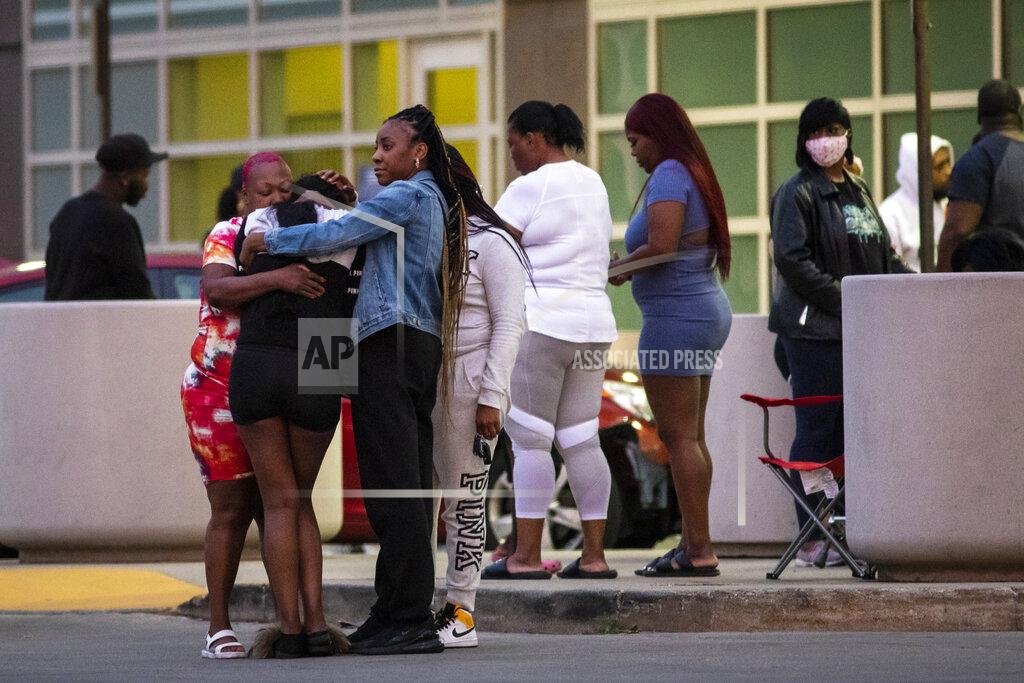 Ashlee Rezin Garcia Hundreds of mourners gather in the parking lot of Stroger Hospital after a 40-year-old man was shot to death in the 700 block of North Spaulding Avenue on Memorial Day, Monday night, May 31, 2021, in Chicago. (Ashlee Rezin Garcia/Chicago Sun-Times via AP)