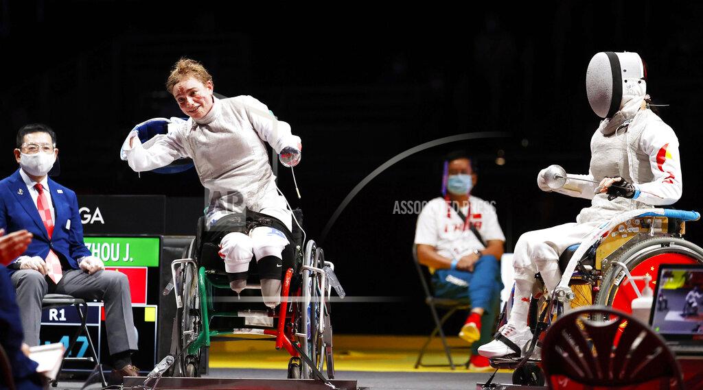 Uncredited FILE - In this Saturday, Aug. 28, 2021 file photo, Italy's Beatrice Maria Vio, left, celebrates after winning over China's Zhou Jingjing during their the wheelchair fencing women's foil Individual category B gold medal match in Chiba, near Tokyo, at the Tokyo 2020 Paralympic Games, in Tokyo, Japan. When Ursula von der Leyen was lost for words to capture the soul of the European Union and its future on Wednesday, Sept. 15, 2021, Bebe Vio was there to help out the EU's top official at the end of her State of the Union address. Sitting anonymously among the European legislators for most of the hour-long speech which is a highlight on the EU calendar, the Italian Paralympic fencer suddenly became the center of attention when the Commission president called her out as the guest of honor of the august proceedings. (Kyodo News via AP, File)