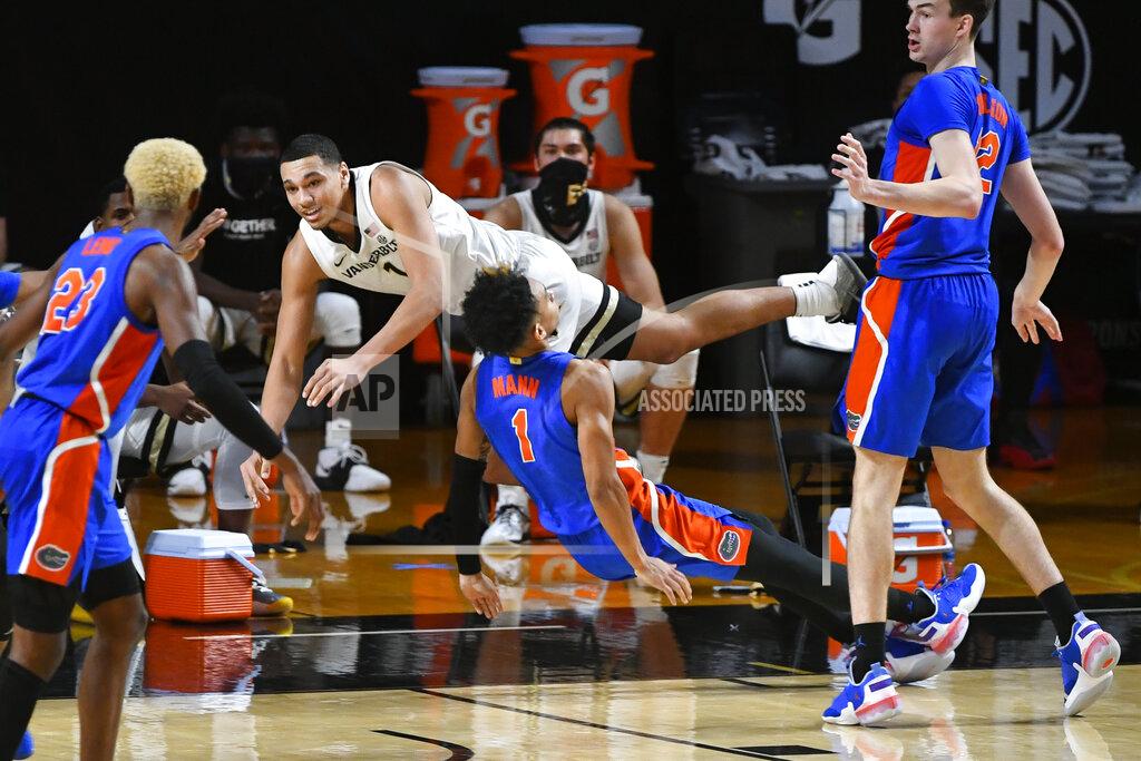 John Amis Vanderbilt forward Dylan Disu collides with Florida guard Tre Mann (1), who was trying to draw a charge during the second half of an NCAA college basketball game Wednesday, Dec. 30, 2020, in Nashville, Tenn. (AP Photo/John Amis)