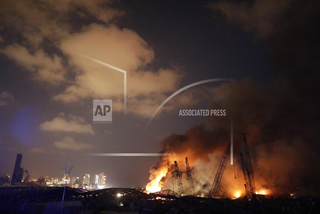 Hassan Ammar Riot police scuffle with anti-government protesters outside the Ministry of Energy and Water in Beirut, Lebanon, Tuesday, Aug. 4, 2020. Dozens of Lebanese protesters attempted to storm the ministry of energy on Tuesday, angered by prolonged power cuts as the country grapples with a crippling economic crisis. (AP Photo/Hassan Ammar)