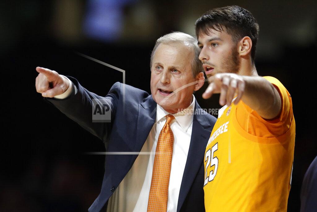 FILE - In this Saturday, Jan. 18, 2020, file photo, Tennessee coach Rick Barnes talks with guard Santiago Vescovi, of Uruguay, during the second half of the team's NCAA college basketball game against Vanderbilt in Nashville, Tenn. With competition canceled across all NCAA divisions due to the coronavirus, many foreign athletes face a dilemma, return home or stay. Tennessee's men’s basketball team has players from France, Serbia, Uruguay and Finland, which meant Mary-Carter Eggert, the director of basketball operations, became a travel agent, looking for the best flights. (AP Photo/Mark Humphrey, File)