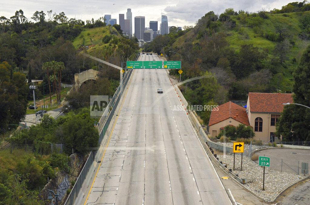 Mark J. Terrill FILE - In this March 20, 2020, file photo, extremely light traffic moves in the mid-afternoon along the 110 Harbor Freeway toward downtown Los Angeles. Auto insurers are short-changing California motorists on refunds that were ordered last year because there have been far fewer motor vehicle accidents during the pandemic, the state's insurance regulator said Thursday, March 11, 2021. (AP Photo/Mark J. Terrill, File)