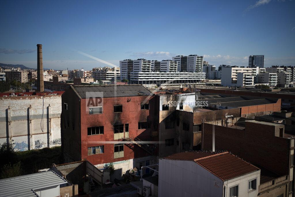 Emilio Morenatti View of a building after a fire in Badalona, Barcelona, Spain, Thursday, Dec. 10, 2020. Firefighters in northeastern Spain found two bodies in an abandoned industrial complex, occupied by migrants and other squatters, that caught fire and partially collapsed, while ongoing emergency work assisted by drones on Thursday tried to assess if more people were trapped inside. (AP Photo/Emilio Morenatti)