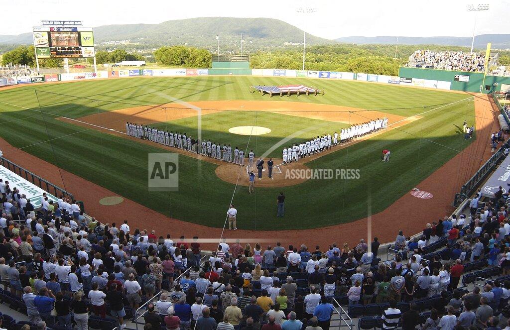 Pat Little FILE - In this June 20, 2006, file photo, teams line up along the baselines during the playing of the national anthem before the first game, in the inaugural season, of the State College Spike baseball team in State College, Pa. Major League Baseball is creating a minor league for top eligible prospects leading to the summer draft., the league announced Monday, Nov. 30, 2020. The founding members of the MLB Draft League are located in Ohio, Pennsylvania, West Virginia and New Jersey: the Mahoning Valley Scrappers, the State College Spikes, the Trenton Thunder, the West Virginia Black Bears and the Williamsport Crosscutters. (AP Photo/Pat Little, File)