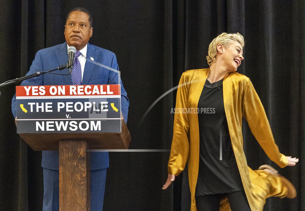 Damian Dovarganes Republican conservative radio talk show host Larry Elder and former actor and activist Rose McGowan hold a news conference at the Luxe Hotel Sunset Boulevard in Los Angeles, Sunday, Sept. 12, 2021. Elder is running to replace Democratic Gov. Gavin Newsom in the Sept. 14 recall election. McGowan was one of the earliest of dozens of women to accuse Hollywood producer Harvey Weinstein of sexual misconduct, making her a major figure in the #MeToo movement. (AP Photo/Damian Dovarganes)