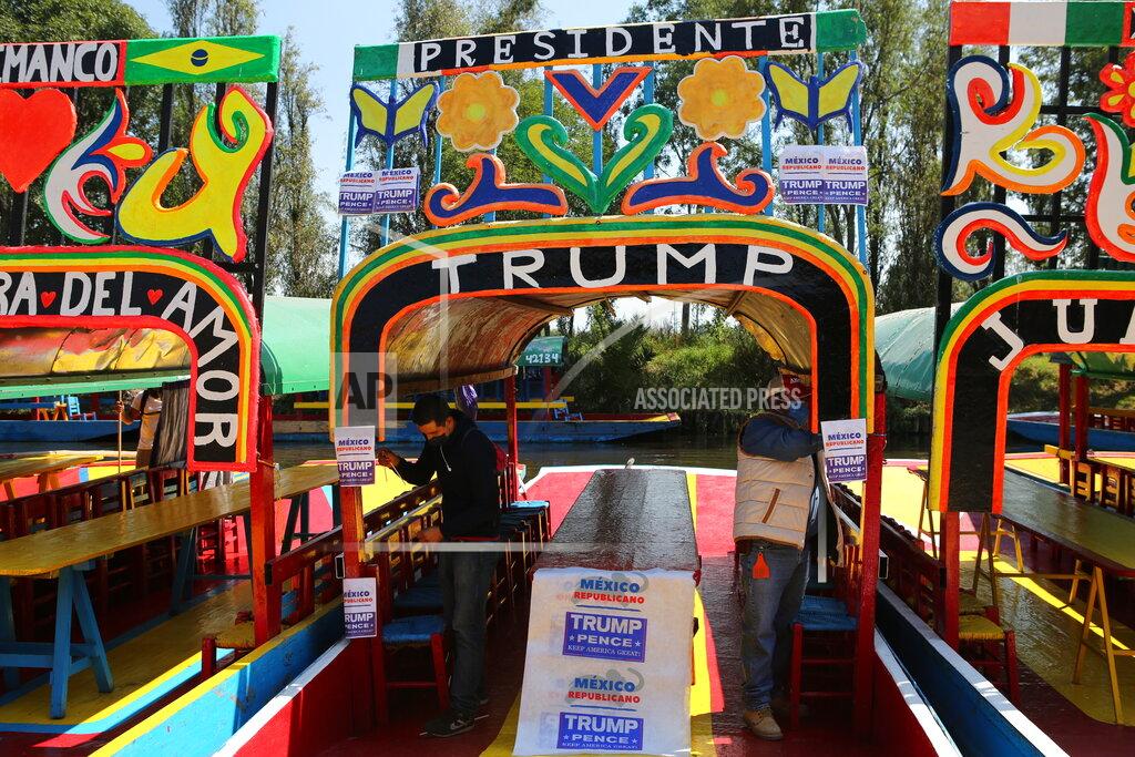Ginnette Riquelme FILE - In this Nov. 1, 2020 file photo people stick flyers in a chinampa in support of the reelection of President Donald Trump, in the Xochimilco district of Mexico City. Mexico's economy is forecast to contract nearly 10% this year -- the biggest decline in the region -- and President Andrés Manuel López Obrador knows any chance of climbing out of that hole will depend greatly on a rapid U.S. economic recovery. Perhaps more important than who wins the White House will be a clear result and stability for its neighbor to the north, since the U.S. and Mexico are each other's biggest trade partners. (AP Photo/Ginnette Riquelme, File)