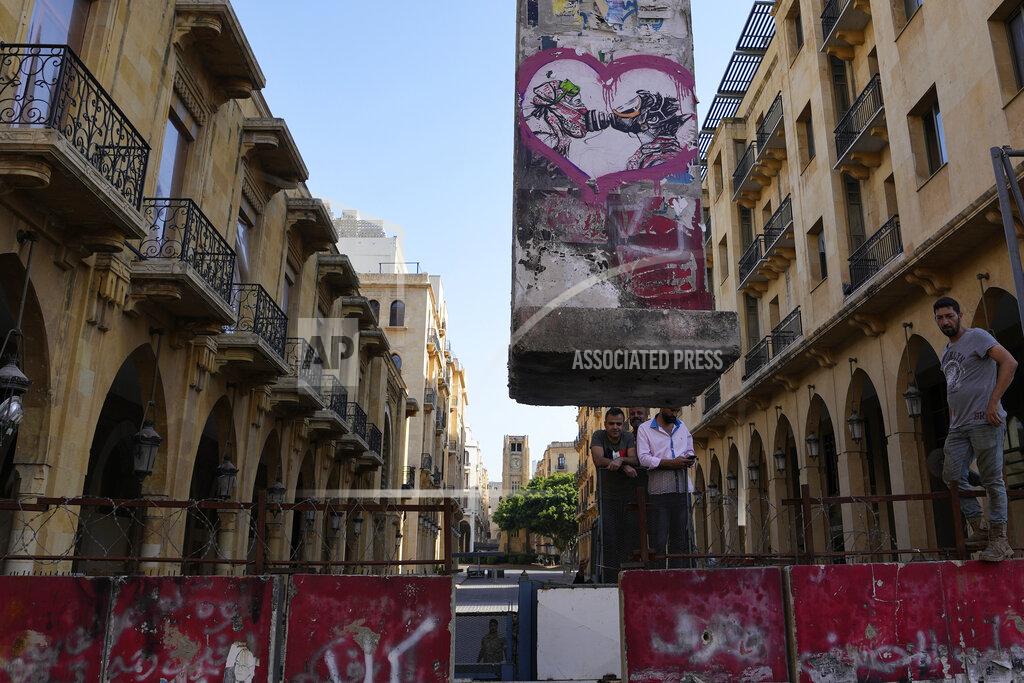 Hassan Ammar A team of engineers removes a concrete wall from a road that leads to the parliament building in Beirut, Lebanon, Monday, May 23, 2022. Lebanese authorities began removing giant cement barriers surrounding the parliament building in Beirut Monday, a week after a new legislature was elected. The blast walls were set up following nationwide protests that erupted in late 2019 amid an economic meltdown. (AP Photo/Hassan Ammar)