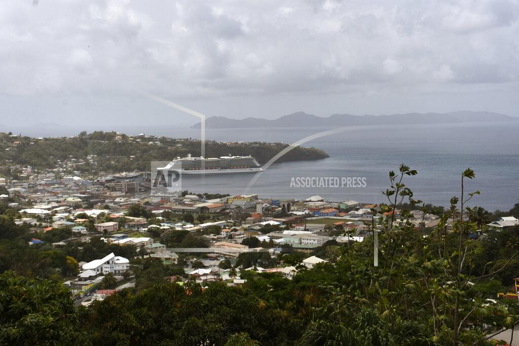 Orvil Samuel The Royal Caribbean cruise ship Reflection sits docked waiting to evacuate a group of British, Canadian and U.S. nationals in Kingstown, on the eastern Caribbean island of St. Vincent, Friday, April 16, 2021. La Soufriere volcano has shot out another explosive burst of gas and ash Friday morning as the cruise ship arrived to evacuate some of the foreigners who had been stuck on a St. Vincent island by a week of violent eruptions. (AP Photo/Orvil Samuel)