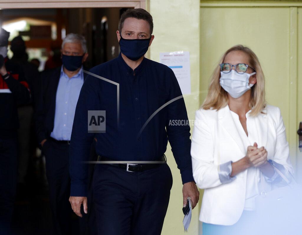 Petr David Josek Presidential candidate Rafal Trzaskowski accompanied by his wife Malgorzata arrives to cast his vote during the presidential election runoff in Rybnik, Poland, Sunday, July 12, 2020. Voting started Sunday in Poland's razor-blade-close presidential election runoff between the conservative incumbent Andrzej Duda and liberal, pro-European Union Warsaw Mayor Rafal Trzaskowski. (AP Photo/Petr David Josek)