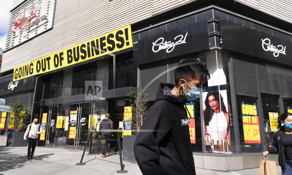 Mark Lennihan FILE - In this Wednesday, Sept. 30, 2020, file photo, a man wearing a mask amid the coronavirus pandemic walks by a Century 21 department store, in the Brooklyn borough of New York. The discount department store chain has filed for Chapter 11 bankruptcy protection and is closing its 13 stores. Responses to the coronavirus pandemic and police brutality dominated legislative sessions in 2020 and led to many new laws that will take effect in the new year. (AP Photo/Mark Lennihan, File)