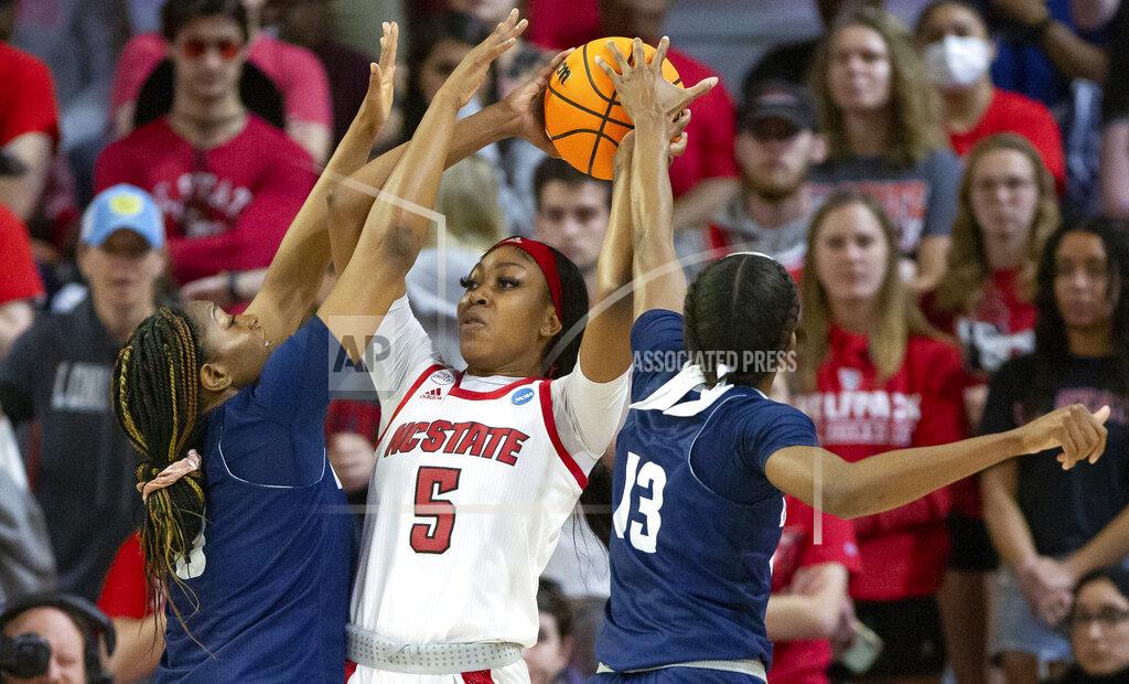 Ben Mckeown North Carolina State's Jada Boyd (5) looks to pass as Longwood's Brooke Anya, left, and Akila Smith (13) defend during the first half of a college basketball game in the first round of the NCAA tournament in Raleigh, N.C., Saturday, March 19, 2022. (AP Photo/Ben McKeown)