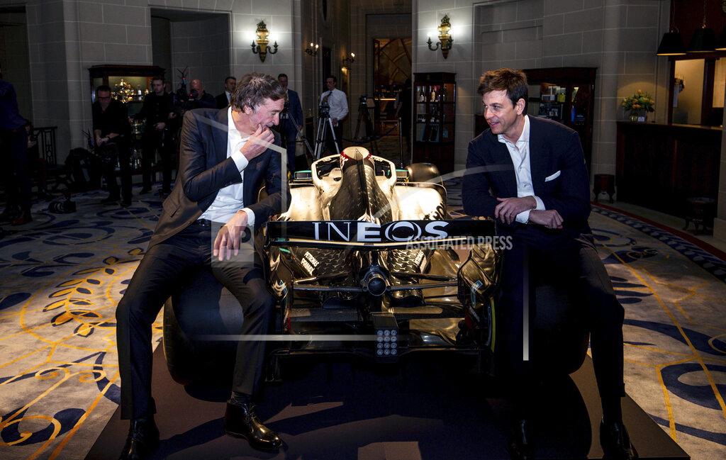 Toto Wolff, Team Principal & CEO of The Mercedes AMG-PETRONAS F1 Team, right, and INEOS Founder and Chairman Jim Ratcliffe pose for a photo with a Mercedes F1 car and its 2020 livery during a media briefing in London, Monday, Feb. 10, 2020. The Mercedes Formula One team is still waiting to secure a long-term commitment from world champion Lewis Hamilton. Wolff says he hasn't spoken to Hamilton since the Christmas party after agreeing to “leave each other in peace” in the offseason. Mercedes has longer certainty from its new sponsor INEOS, the chemicals giant owned by Jim Ratcliffe. (Steven Paston/PA via AP)