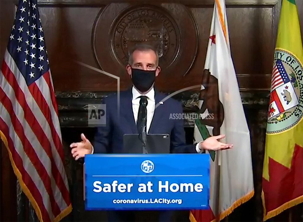 La330 FILE - This April 2, 2020 file still image taken from a live stream provided by Office of the Mayor shows Los Angeles Mayor Garcetti with a protective face mask during his daily news conference in Los Angeles. Garcetti has taken his name out of consideration for a possible post in the Biden administration. (Office of the Mayor via AP, File)