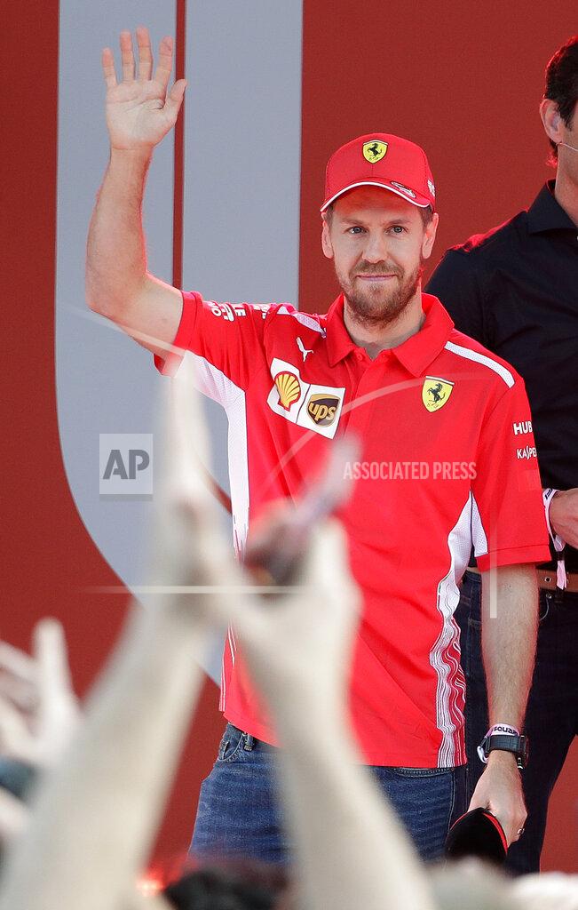 Rick Rycroft Ferrari driver Sebastian Vettel of Germany waves during the launch for the Australian Grand Prix in Melbourne, Australia, Wednesday, March 13, 2019. (AP Photo/Rick Rycroft)