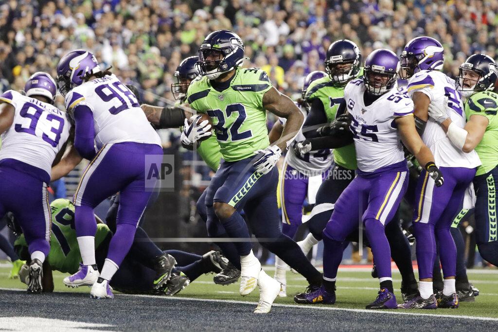 Seattle Seahawks' Chris Carson, center, scores on a run against the Minnesota Vikings during the first half of an NFL football game, Monday, Dec. 2, 2019, in Seattle. (AP Photo/Ted S. Warren)