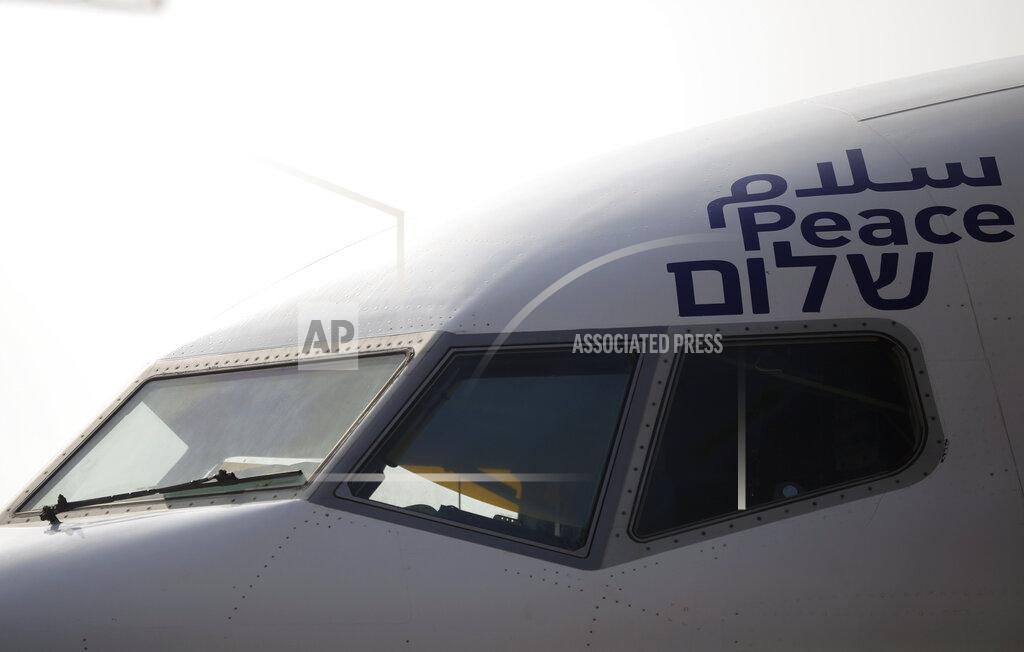 The Arabic, English and Hebrew word for "peace" is seen on the Israeli flag carrier El Al's airliner which will carry Israeli and U.S. delegations to Abu Dhabi for talks meant to put final touches on the normalization deal between the United Arab Emirates and Israel, at Ben Gurion Airport, near Tel Aviv, Israel Monday, Aug. 31, 2020. (Nir Elias/Pool Photo via AP)