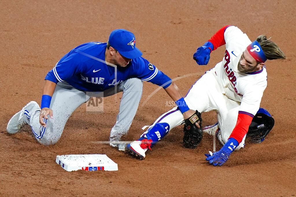 Matt Slocum Philadelphia Phillies' Bryce Harper, right, is tagged out at second by Toronto Blue Jays second baseman Joe Panik after trying to stretch a single during the first inning of the second baseball game in a doubleheader, Friday, Sept. 18, 2020, in Philadelphia. (AP Photo/Matt Slocum)