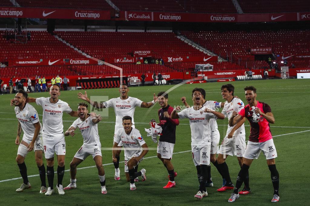 Str Sevilla players celebrate their Spanish La Liga soccer match victory against Betis in Seville, Spain, Thursday, June 11, 2020. With virtual crowds, daily matches and lots of testing for the coronavirus, soccer is coming back to Spain. The Spanish league resumes this week more than three months after it was suspended because of the pandemic, becoming the second top league to restart in Europe. The Bundesliga was first. The Premier League and the Italian league should be next in the coming weeks. (AP Photo)