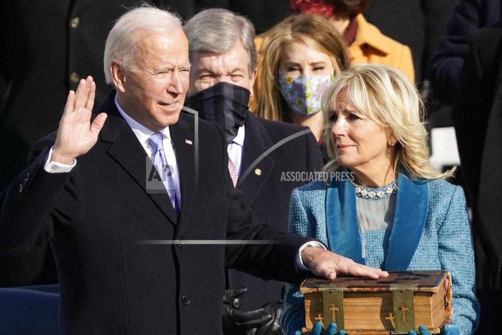 Andrew Harnik Joe Biden is sworn in as the 46th president of the United States by Chief Justice John Roberts as Jill Biden holds the Bible during the 59th Presidential Inauguration at the U.S. Capitol in Washington, Wednesday, Jan. 20, 2021. (AP Photo/Andrew Harnik)