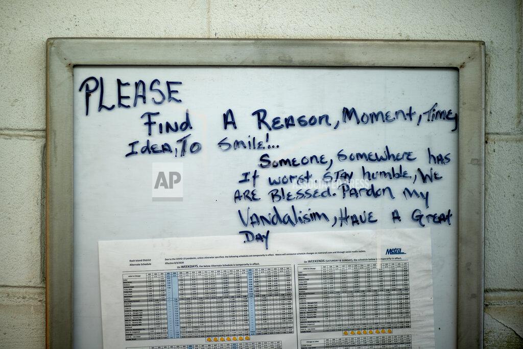 David Goldman A motivational message is written on a timetable at a Metra train line station in the Auburn Gresham neighborhood in Chicago, Thursday, Aug. 27, 2020. As this agonizing year nears an end, some in Auburn Gresham are looking ahead, with hope. (AP Photo/David Goldman)