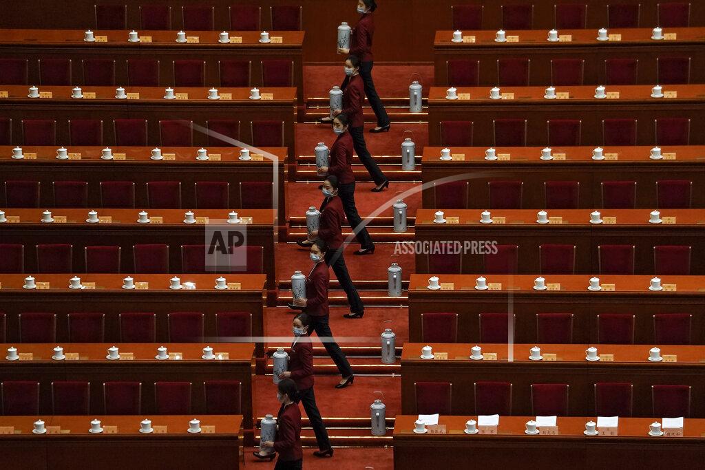 Tea hostesses wearing face masks to help curb the spread of the coronavirus prepare tea for members of the National Committee of the Chinese People's Political Consultative Conference (CPPCC) ahead of the opening session of the CPPCC at the Great Hall of the People in Beijing, Thursday, March 4, 2021. (AP Photo/Andy Wong)