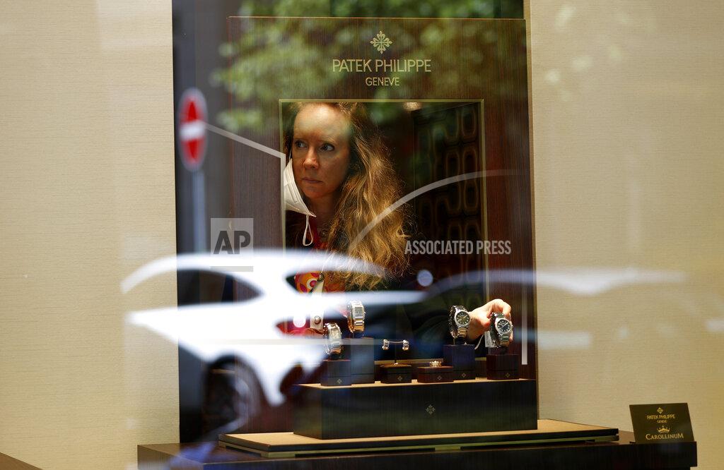 Petr David Josek A woman adjusts watches in a shop in Prague, Czech Republic, Monday, May 10, 2021. The Czech Republic is massively relaxing its coronavirus restrictions as the hard-hit nation pay respect to nearly 30,000 dead. Monday's wave of easing came after the new infections fell to the levels unseen from August when the government failed to react in time to an opposite trend, the growing numbers of infected which later contributed to record numbers of deaths. (AP Photo/Petr David Josek)