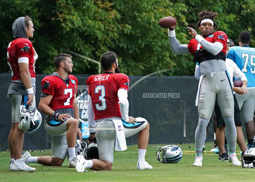 Chuck Burton Carolina Panthers' Cam Newton (1) warms up as fellow quarterbacks, from left to right, Taylor Heinicke, Kyle Allen and Will Grier watch during practice at the NFL football team's training camp in Spartanburg, S.C., Sunday, July 28, 2019. (AP Photo/Chuck Burton)