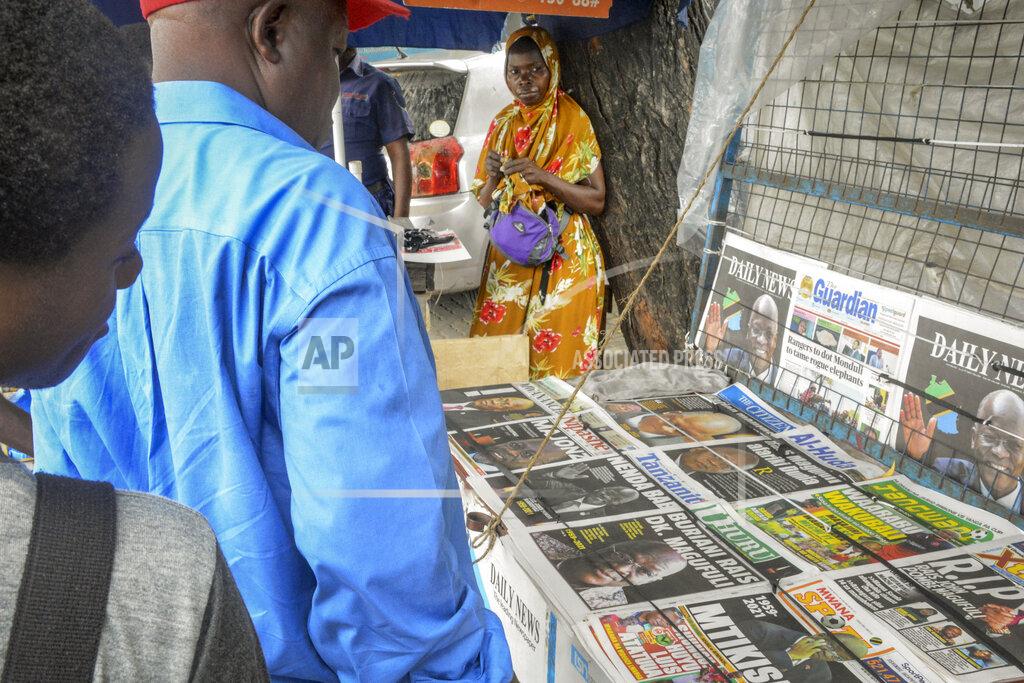 Uncredited A newspaper stand displays front pages reporting the death of Tanzania's President John Magufuli, on a street in Dar es Salaam, Tanzania Thursday, March 18, 2021. President John Magufuli of Tanzania, a prominent COVID-19 skeptic whose populist rule often cast his country in a harsh international spotlight, died aged 61 of heart failure, it was announced by Vice President Samia Suluhu Hassan on Wednesday. (AP Photo)