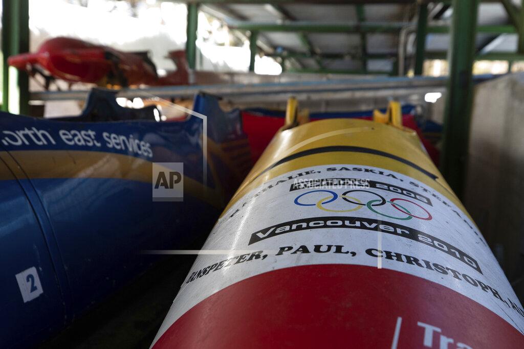 Gabriele Facciotti Bobsleds are stored next to the course in Cortina d'Ampezzo, Italy, Wednesday, Feb. 17, 2021. Bobsledding tradition in Cortina goes back nearly a century and locals are hoping that the Eugenio Monti track can be reopened for the 2026 Olympics in the Italian resort. (AP Photo/Gabriele Facciotti)