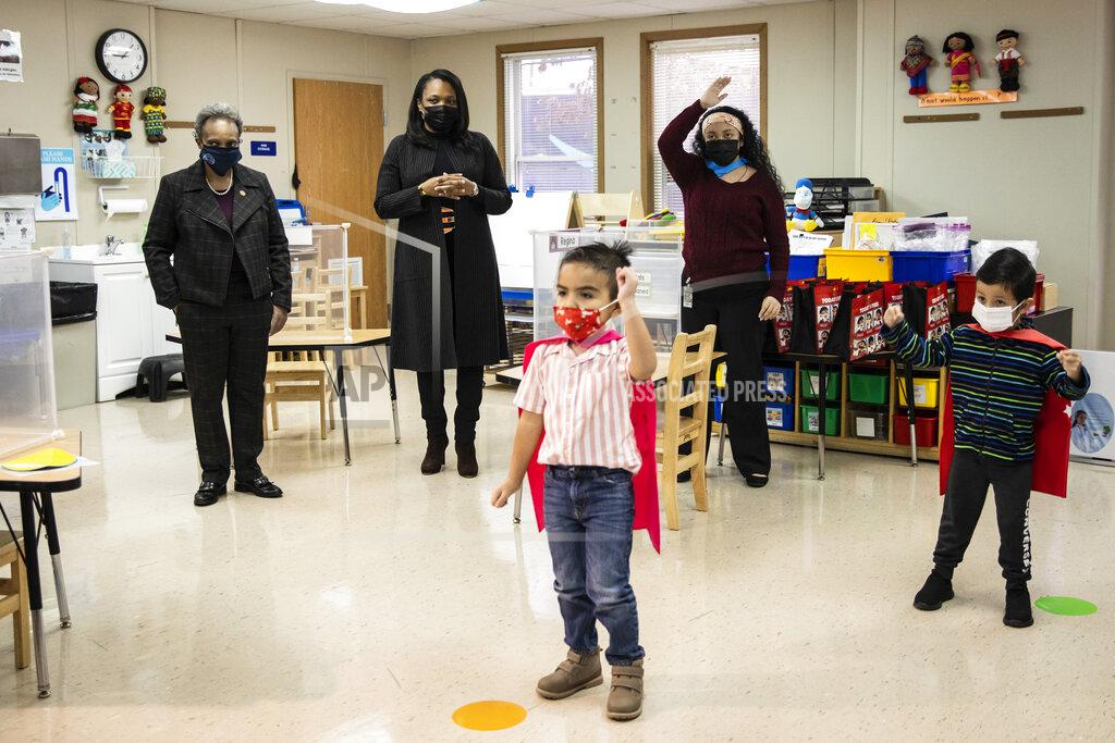 Mayor Lori Lightfoot, left, and Chicago Public Schools CEO Janice Jackson, second from left, visit a preschool classroom at Dawes Elementary School in Chicago, Monday, Jan. 11, 2021. Monday was the first day of optional in-person learning for preschoolers and some special education students in Chicago Public Schools after going remote last March due to the coronavirus pandemic. (Ashlee Rezin Garcia/Chicago Sun-Times via AP, Pool)