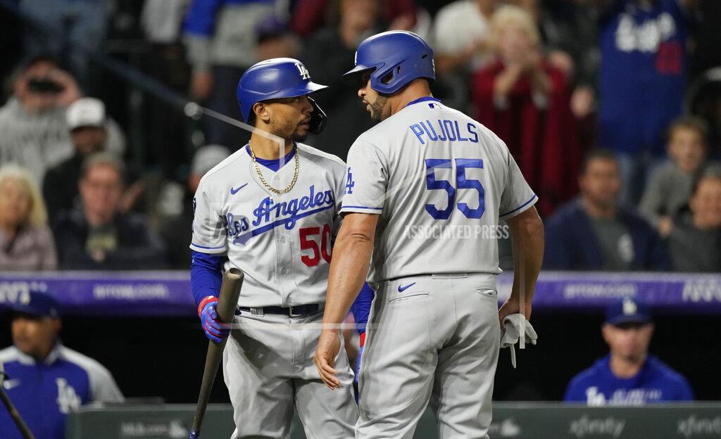 David Zalubowski Los Angeles Dodgers' Mookie Betts, left, congratulates pinch-hitter Albert Pujols as he returns to the dugout after hitting an RBI-single off Colorado Rockies relief pitcher Jhoulys Chacin in the 10th inning of a baseball game Tuesday, Sept. 21, 2021, in Denver. The Dodgers won 5-4. (AP Photo/David Zalubowski)